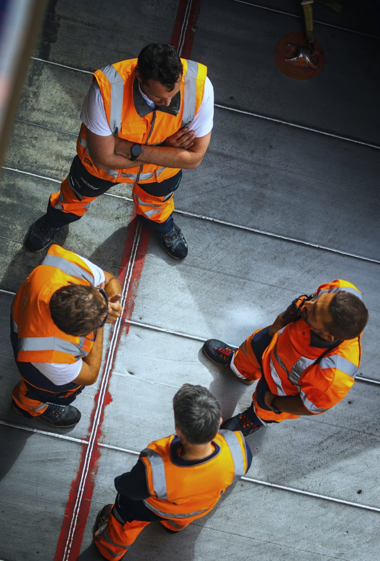Site engineers in hi-vis discussing work on a data centre floor